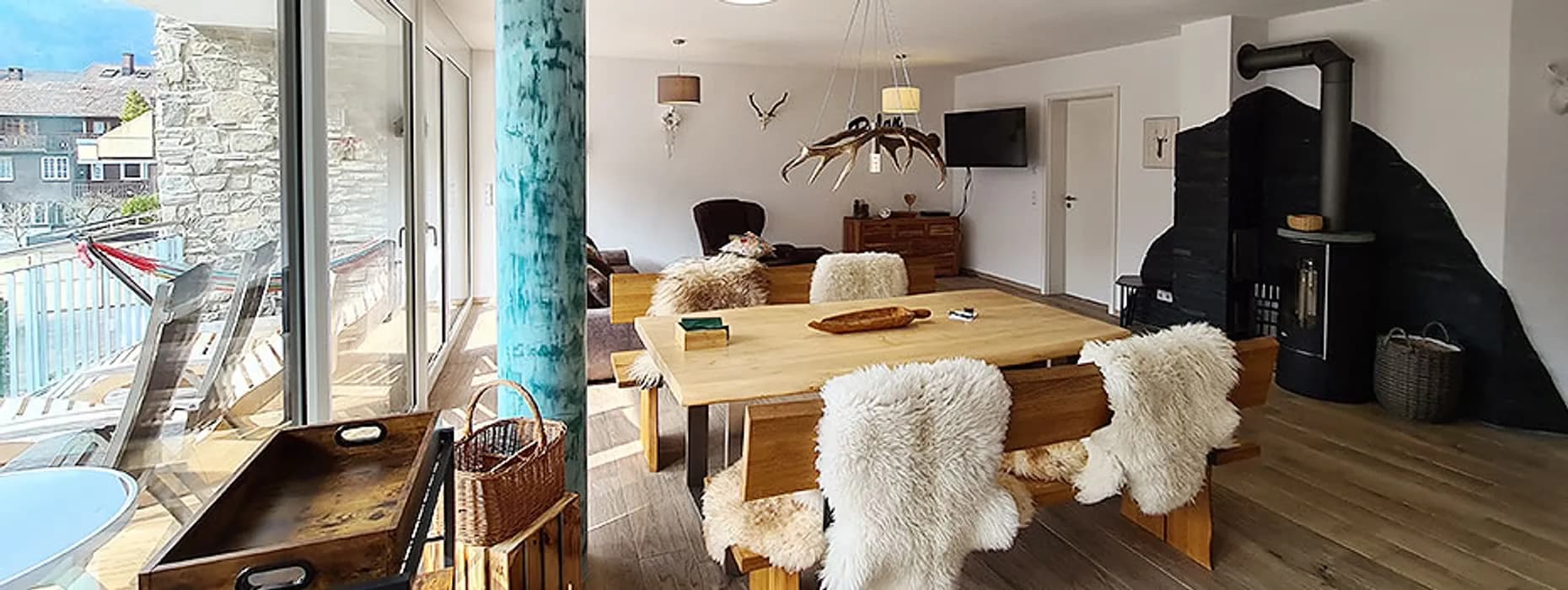 Esstisch aus Massivholz mit Sitzbänken und Fellen in der Wohnung Talblick